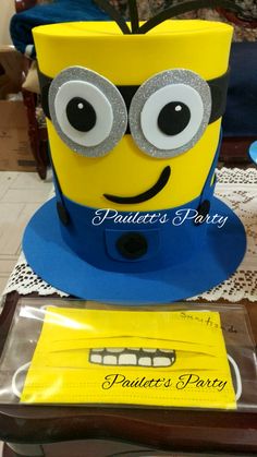 a cake made to look like a minion sitting on top of a table with eyes