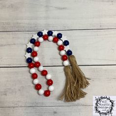 a red, white and blue beaded tassel with an american flag pinata