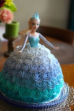 there is a cake that looks like a princess on the table