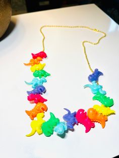 "The perfect Whimsical necklace for the perfect Dino lover! Available on a gold tone or silver tone necklace. Silver is 18\", gold in 16\", 18\", 20\", 22\".  While the materials are simple, it does take time to make. Price includes time to make." Dino Necklace, Decora Accessories, Printable Paper Patterns, Teacher Jewelry, Whimsical Necklace, Dinosaur Necklace, Lover Jewelry, Spring Bracelet, Whimsical Jewelry