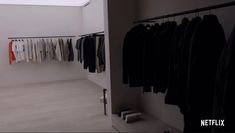 a room with clothes hanging on the wall