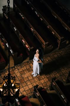 a woman standing in the middle of a church aisle