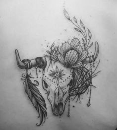 a woman's back with a cow skull and flowers on her head, surrounded by feathers