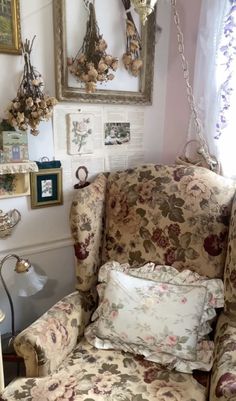 a living room filled with furniture and pictures on the wall