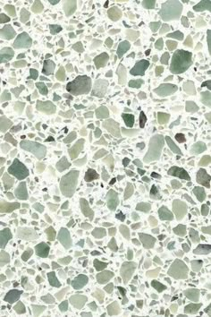 a white and green stone wallpaper with lots of small rocks on it's surface