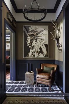 a living room with a chair and painting on the wall