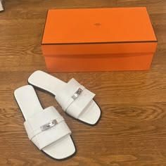 New Hermes Giulia Sandal Slide Size 41.5 White Palladium Kelly Buckle Calfskin. Brand New In Box Comes With Original Box And Dust Bags Never Worn All Stickers Still Attached To Cover The Buckle Size 41.5 White Leather Sandal In Calfskin With Iconic Palladium-Plated Kelly Buckle. A Sleek Design For A Chic Feminine Look. Made In Italy Black Leather Sole Black Leather Heel Palladium-Plated Buckle White Goatskin Insole And Lining Hermes Heels, Hermes Limited Edition, Hermes Slides, Hermes Oran Sandals, Brown Suede Loafers, White Leather Sandals, Ballerina Shoes Flats, Brown Leather Loafers, Hermes Shoes