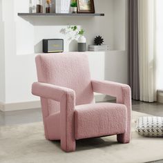 a pink chair sitting on top of a white rug