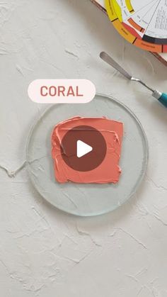 a plate that has some paint on it and the words coral written in white above it