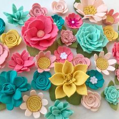 there are many flowers made out of felt