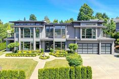 a large house with lots of windows and landscaping