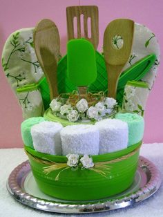 a green cake with wooden spoons and utensils in it