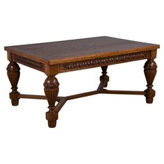 a wooden coffee table with carved legs and a wood top on an isolated white background