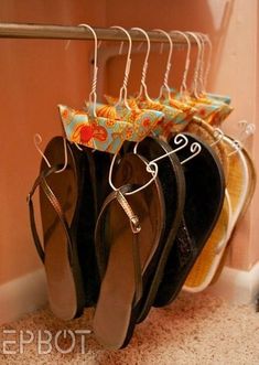 several pairs of shoes are hanging on a rack