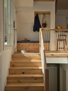 a wooden staircase leading up to a kitchen