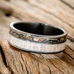 the wedding band is made out of antler and white marble with black inlays