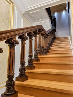 a wooden staircase with handrails in a house