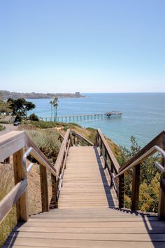 a wooden walkway leading to the ocean