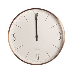 a white and gold clock with black numbers on the face is shown against a white background