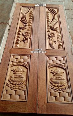 two wooden doors with carvings on them and one is carved into the side of the door