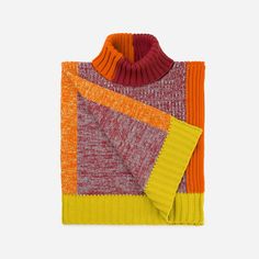 an orange, red and yellow sweater with two different colors on the sides is shown