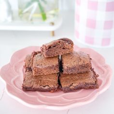 brownies stacked on top of each other on a pink plate