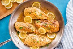 chicken with lemons and herbs in a pan