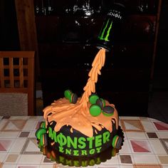 a monster truck birthday cake with green and black icing on it's head