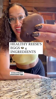 a woman holding up a chocolate doughnut with the words healthy reese's eggs 4 ingredients