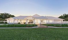 a white house sitting on top of a lush green field