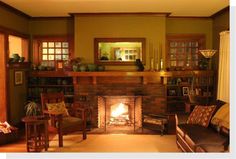 a living room filled with furniture and a fire place in the middle of it's fireplace