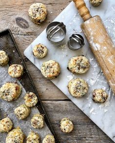 some cookies are sitting on a table next to a rolling pin