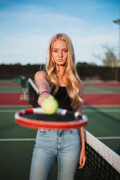 a woman hitting a tennis ball with a racquet