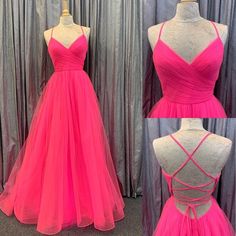 Flaunt your impeccable fashion sense with this chic prom dress. The ethereal ensemble is crafted from soft tulle material, creating a ravishing A-line silhouette that flows gracefully down to the floor. The wrap-over bodice is ultra-flattering, featuring a V-cut neckline that accentuates your curves. Thin straps wrap into a lace-up open back, ensuring the perfect fit and adding a touch of sophistication to the dress. With its delicate fabric and elegant design, this dress will make you feel like Grad Dresses Hot Pink, Prom Dresses Fuscia, Hot Pink Tulle Prom Dress, Hot Pink Corset Prom Dress, Puffy Hot Pink Prom Dress, Chic Prom Dresses, Tulle Material, Dress Display, Tulle Sleeves