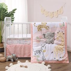 a baby crib bedding set with an elephant and giraffe theme