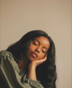 a woman with her eyes closed sitting down