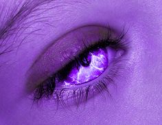 an eye is shown with purple light coming from the iris's irise lens