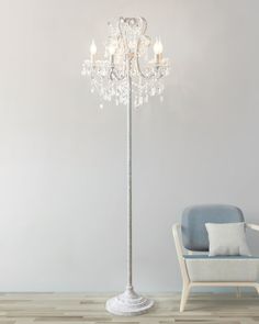 a white floor lamp next to a blue chair