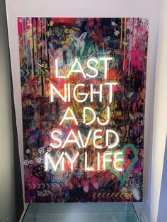 a display case with graffiti written on the wall and below it is a large poster that says, last night adu saved my life