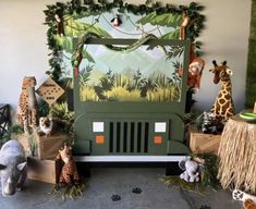 an assortment of stuffed animals and giraffes on display in front of a truck