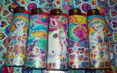 several colorful unicorns are lined up in a row on a wallpapered surface