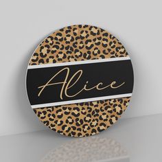 an animal print coaster with the name alice on it