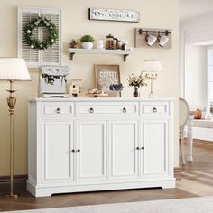 a living room with white furniture and decor