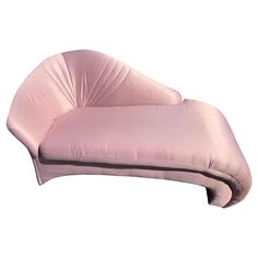 an upholstered chaise lounge chair in pink velvet with curved backrests