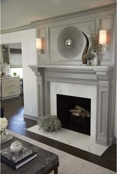 a living room filled with furniture and a fire place under a clock on the wall