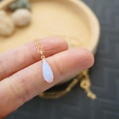 These dainty opal earrings showcase a iridescent teardrop shaped opalite stones on 14K gold filled ear wires. Simple yet eye-catching, they make a beautiful gift for jewelry lover, with their soft shimmer and minimal design. Matching necklace features the same opal pendant suspended on a 14K gold filled chain. Purchase them separately or together as a set and get an extra 10% off your purchase. DIMENSION :Opalite stones : 5 mm x 15 mmEarrings 1 inch long Necklace length : 18 inches Dainty Opal Necklace, Opal Necklace Gold, Earrings Necklace Set, Opal Pendant Necklace, Gold Charm Necklace, Earrings Dainty, Teardrop Necklace, Opal Stone, Necklace Dainty