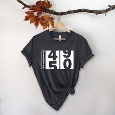 a t - shirt that says over it hanging on a tree branch