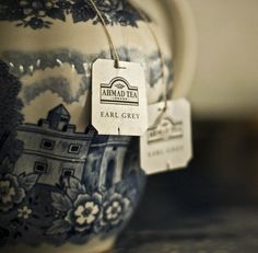 a close up of a tea pot with a tag on it