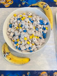 a bowl filled with cereal next to two bananas on a blue and white table cloth