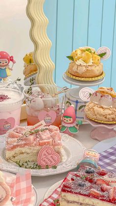 a table topped with lots of different types of cakes and desserts on top of plates